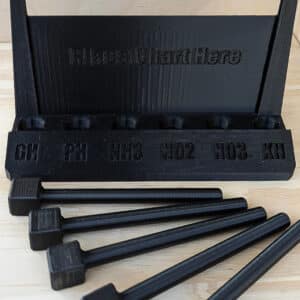 A set of black hammers on a wooden table by DMI 3D, Inc.