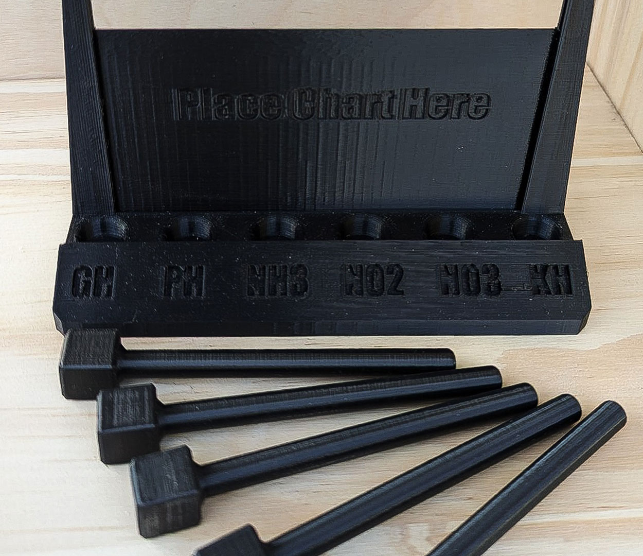 A set of black hammers on a wooden table by DMI 3D, Inc.