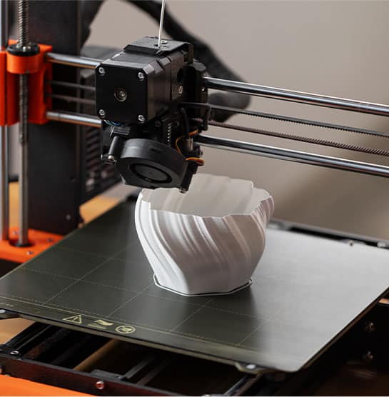 A DMI 3D printer with a cup on it.