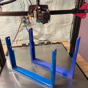 A 3D printer with a blue stand, perfect for your portfolio.